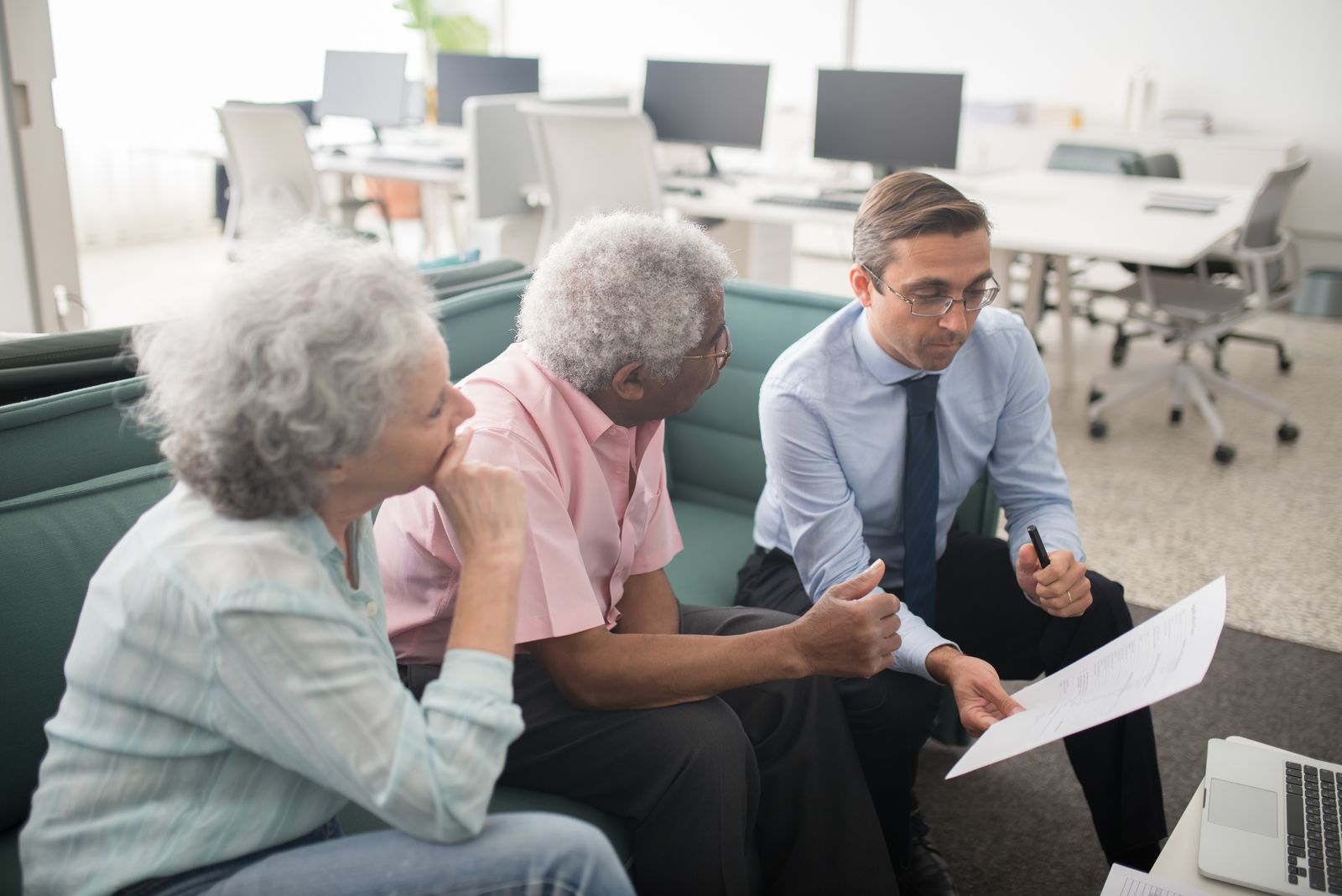 A couple reviewing financial information with a professional